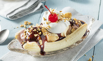 The best banana split topped with cherry, whipped cream, chocolate fudge and nuts served at Mr. Puff's Hand-Rolled Ice Cream in Panama City Beach Florida